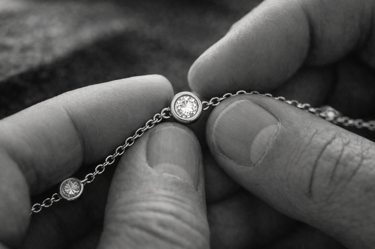 A close-up of a hand-finished solid 14k gold chain featuring bezel-set diamonds, showcasing the craftsmanship and quality of Montkai fine jewelry.