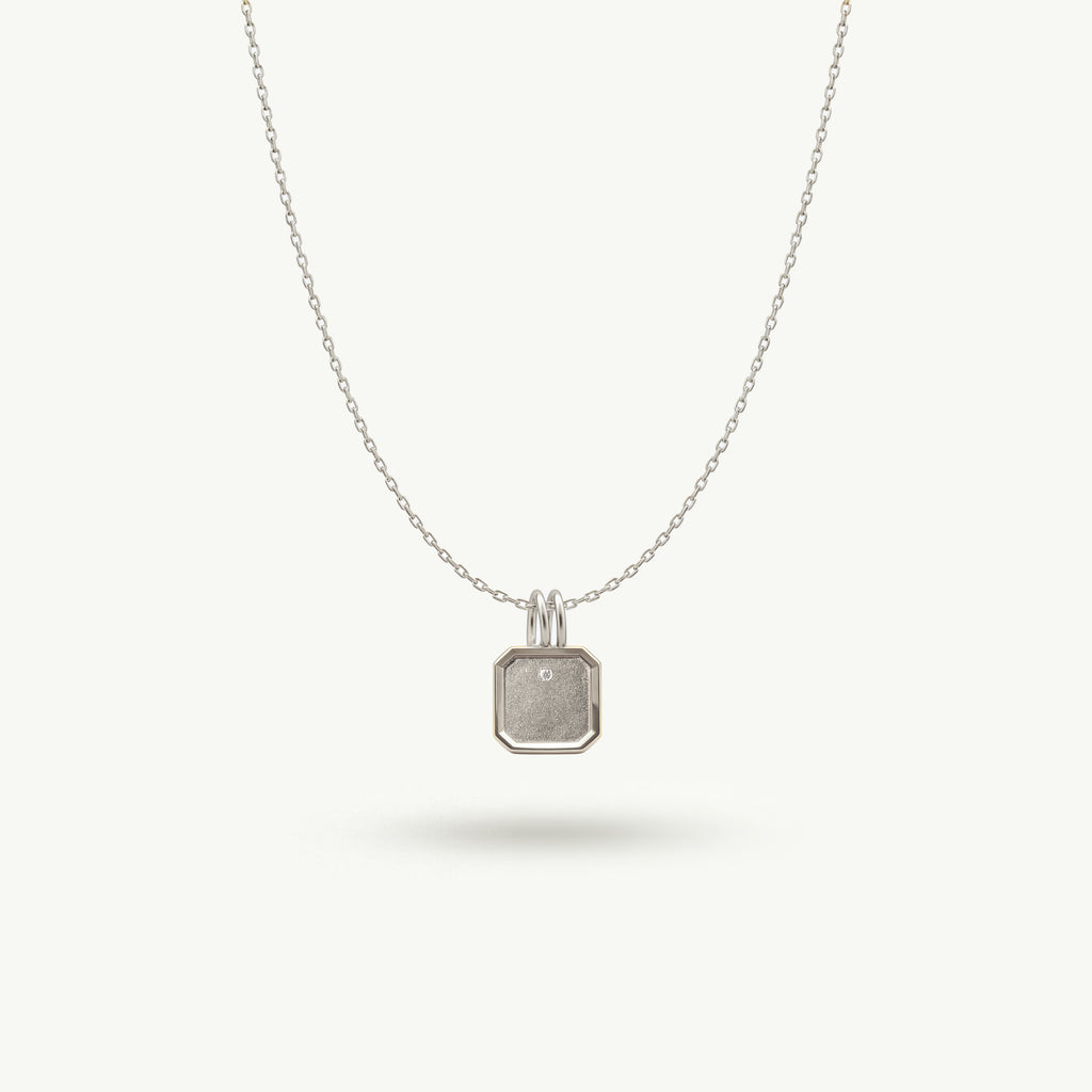 Architectural white gold Bria necklace featuring a precisely formed rectangular pendant with a quiet presence and a single brilliant diamond accent.