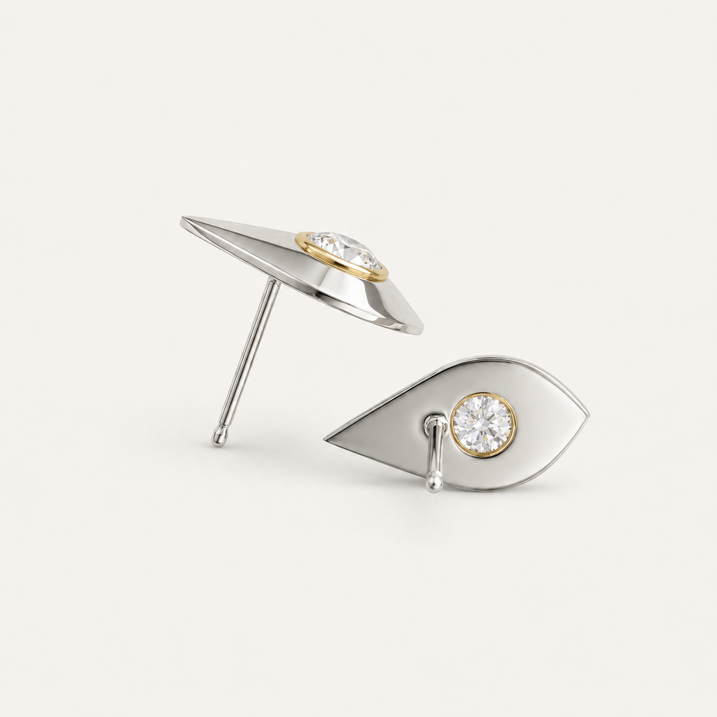 Architectural sterling silver earrings shown from side and back angles with bezel-set white sapphires and gold detailing