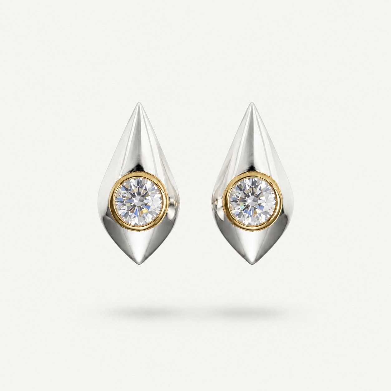 Architectural sterling silver drop earrings with round bezel-set white sapphire stones and gold detailing