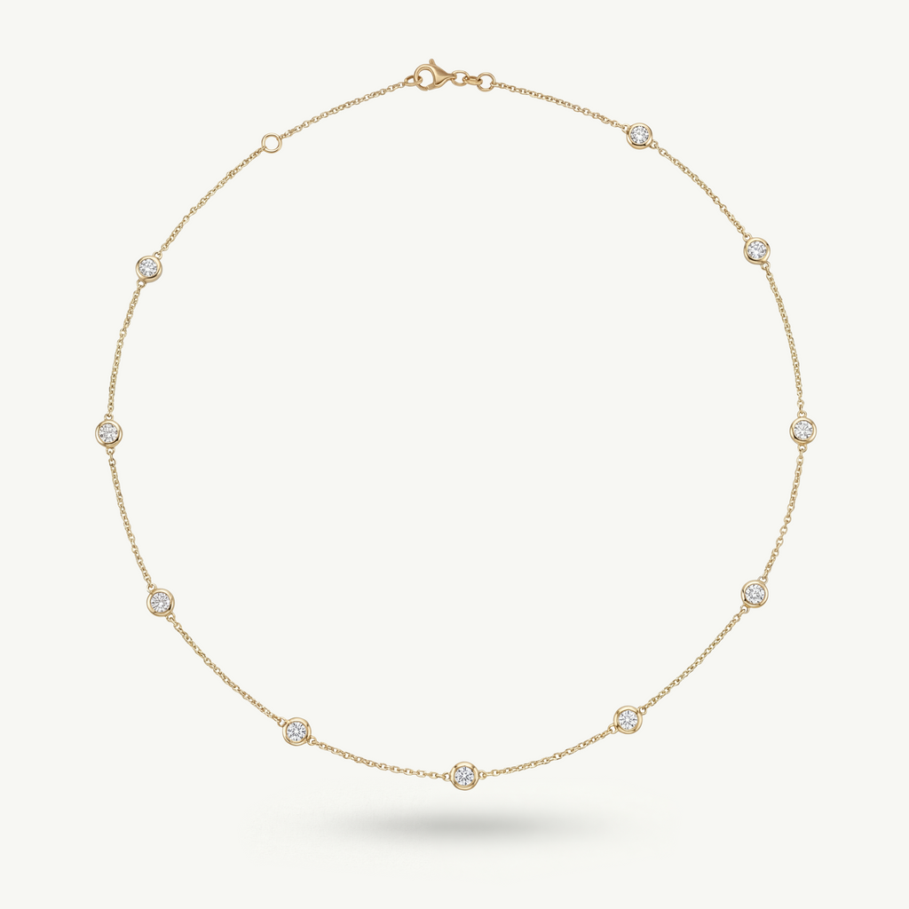 14k solid yellow gold Luma necklace featuring bezel-set diamonds on a fine-link chain, designed for a minimal and restrained aesthetic.