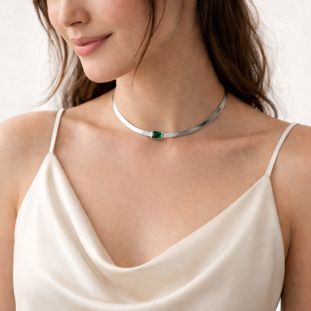 Model wearing the Yorke emerald necklace, demonstrating its quiet presence and intentionally restrained design as a sophisticated everyday signal.